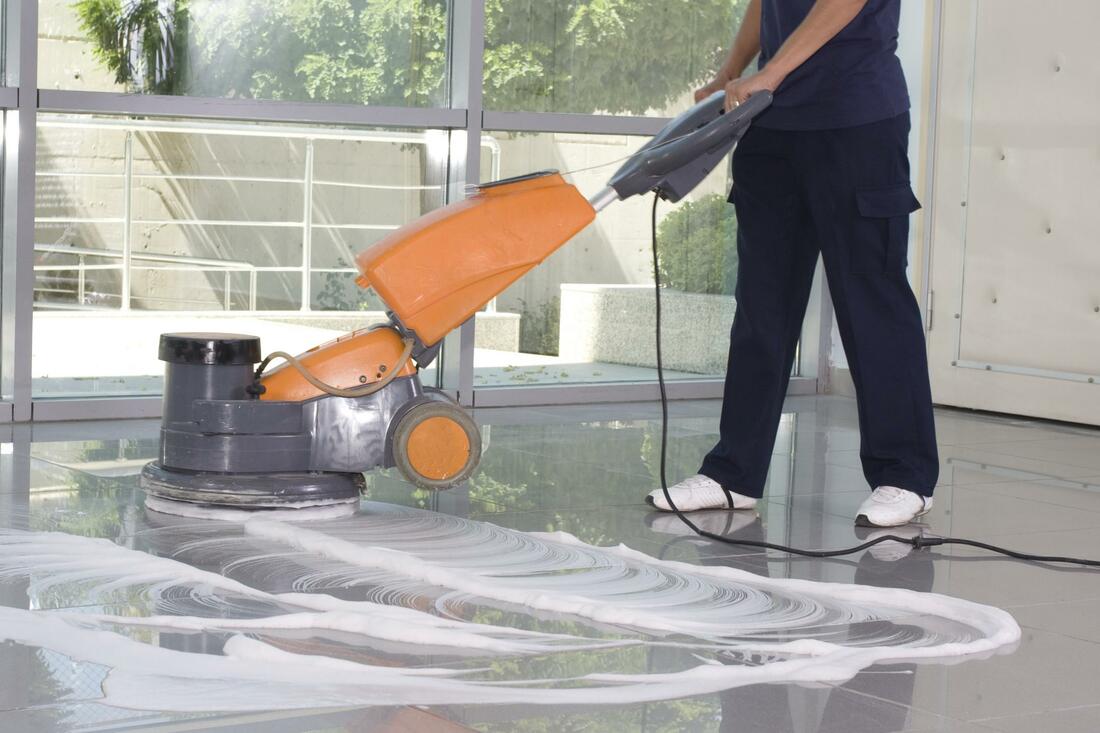 a man using a floor scrubber