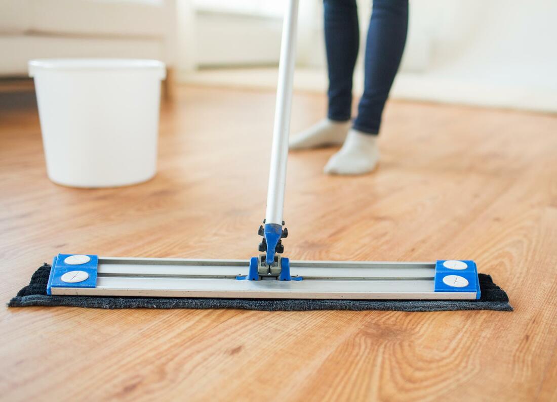 someone using a micro fiber dust mop